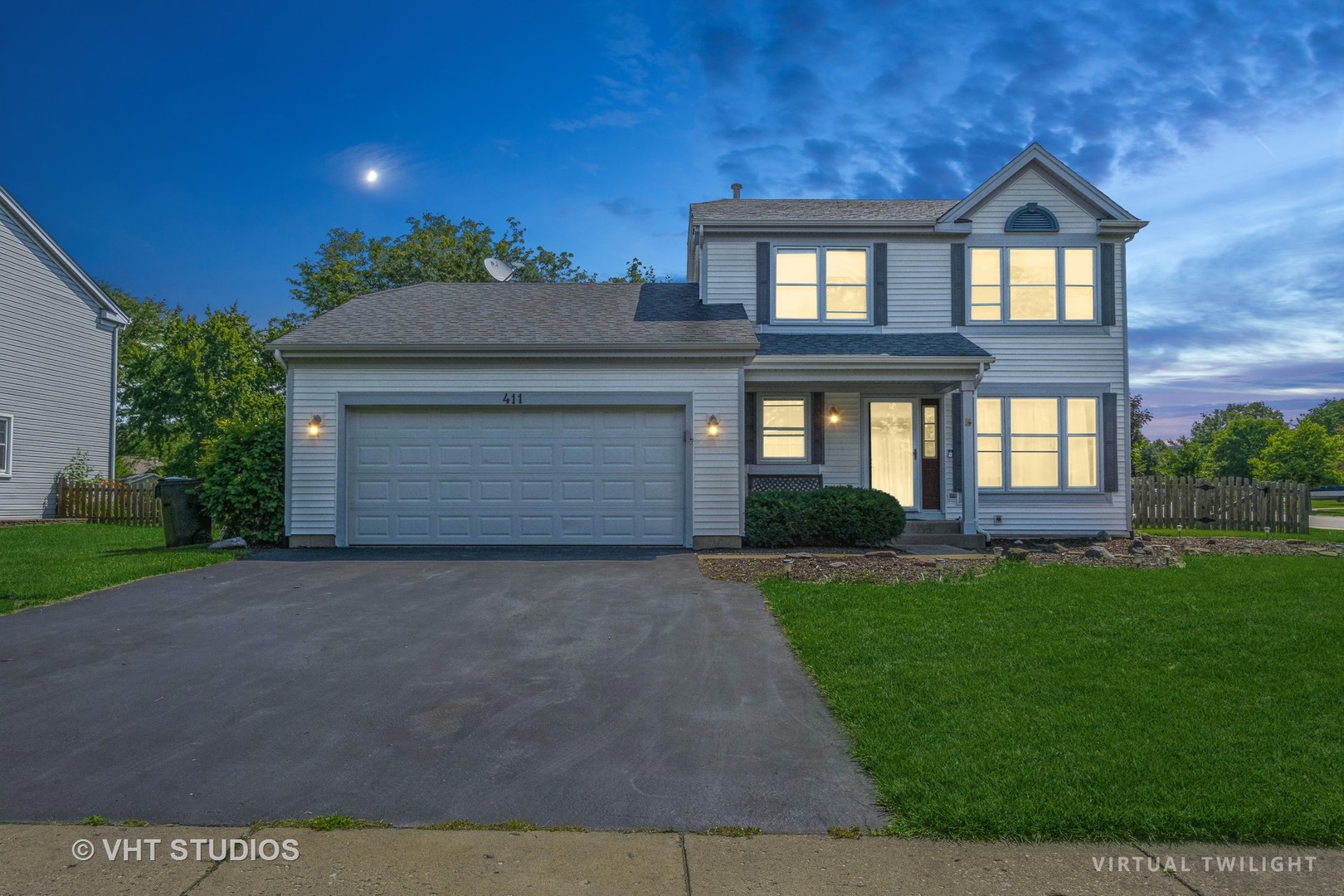 411 Ashfork Trail Cary, IL 60013 - Photo 1 of 25 a front view of a house with a yard and garage