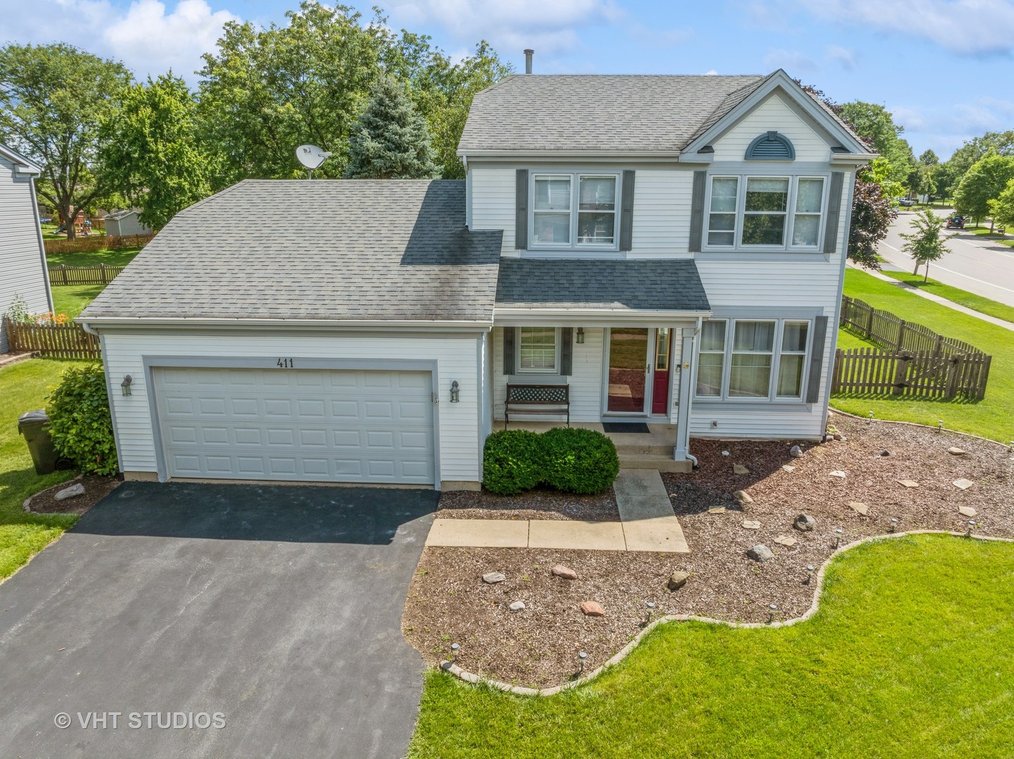 411 Ashfork Trail Cary, IL 60013 - Photo 16 of 25 a front view of a house with a yard and garage