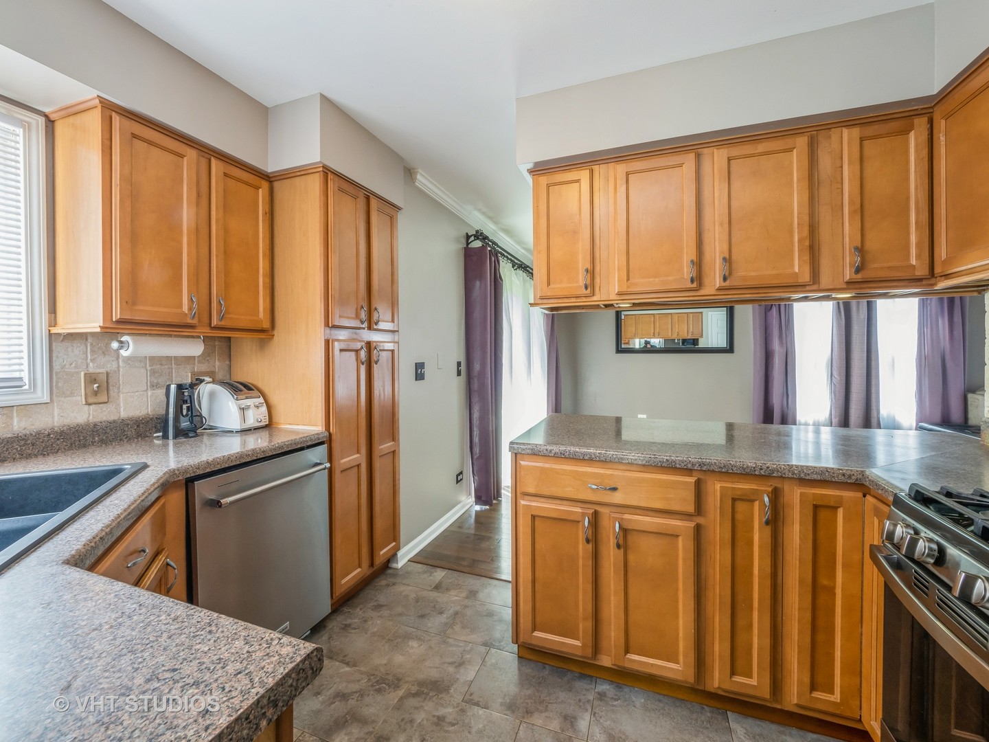 411 Ashfork Trail Cary, IL 60013 - Photo 5 of 25 a kitchen with a stove a sink and a refrigerator