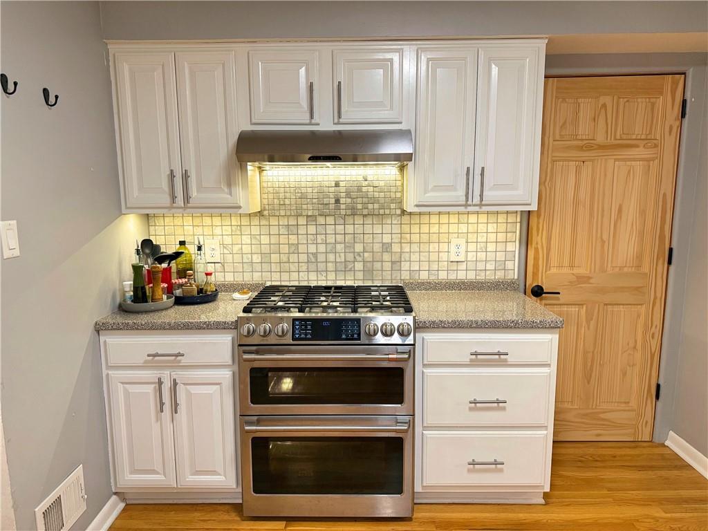 50 Philander Street Pittsburgh, PA 15218 - Photo 18 of 44 a kitchen with granite countertop white cabinets and appliances