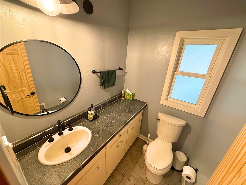 50 Philander Street Pittsburgh, PA 15218 - Photo 20 of 44 a bathroom with a toilet mirror and sink