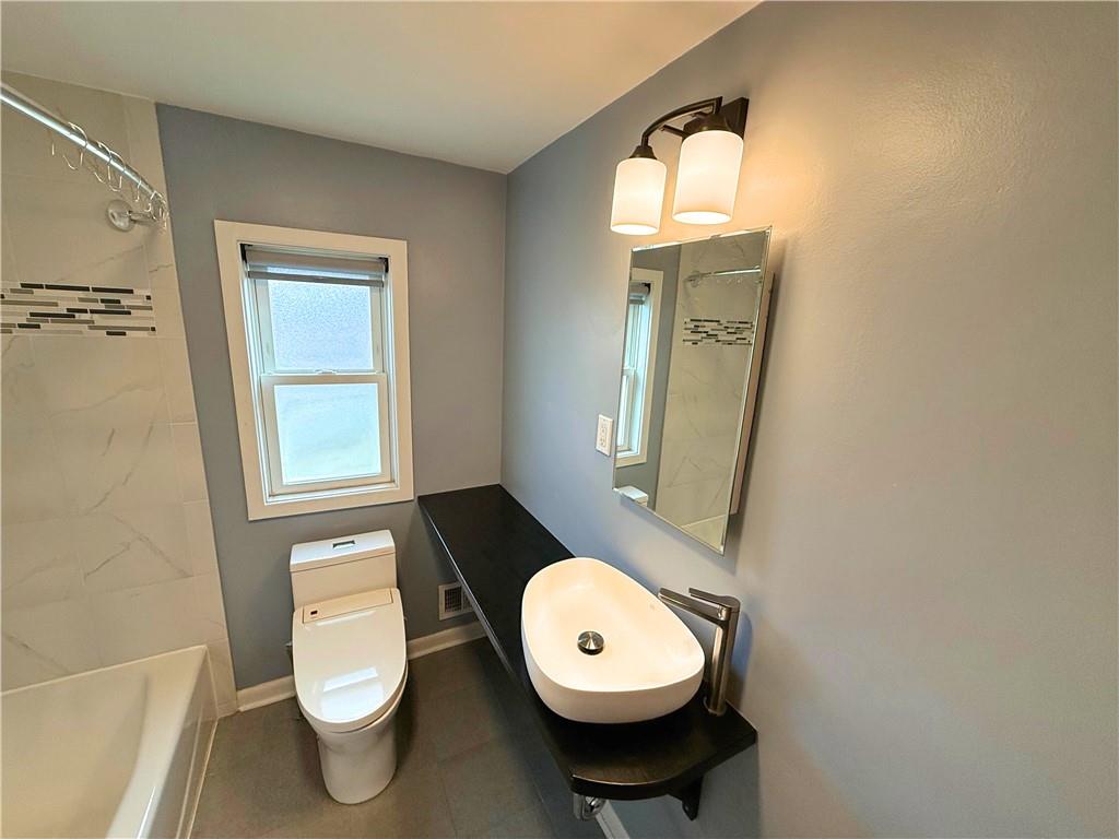 50 Philander Street Pittsburgh, PA 15218 - Photo 24 of 44 a bathroom with a toilet sink and mirror