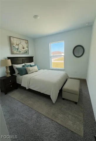 a bedroom with bed couch and window