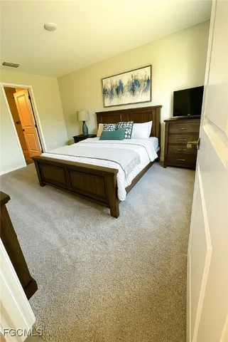 a bedroom with a bed and flat screen tv