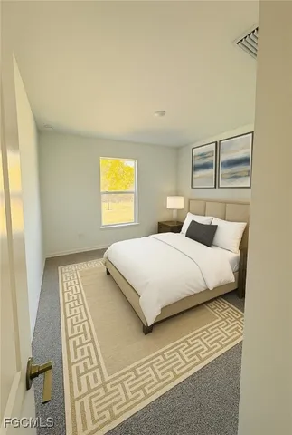 a bedroom with a large bed and a window