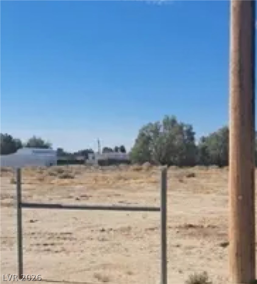 Vicky Ann Road Pahrump, NV 89048 - Photo 1 of 3 A spacious, undeveloped lot with a distant view of structures and mature trees.