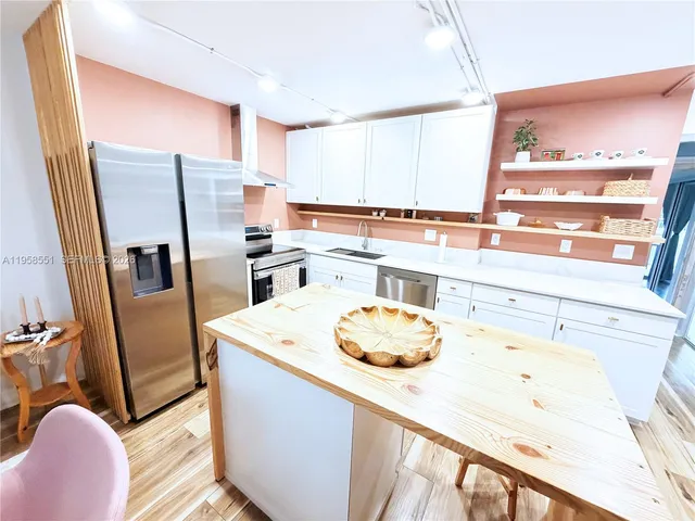 a kitchen with a sink a stove and refrigerator