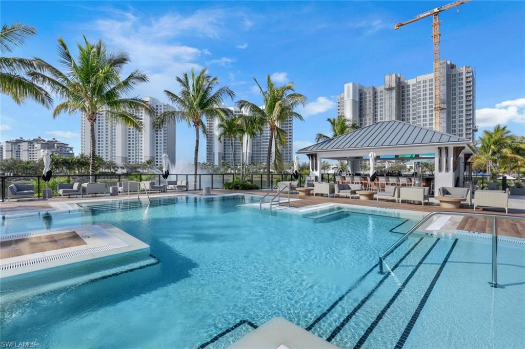 13915 Old Coast Road, Unit 502 Naples, FL 34110 - Photo 25 of 42 a swimming pool with outdoor seating and yard