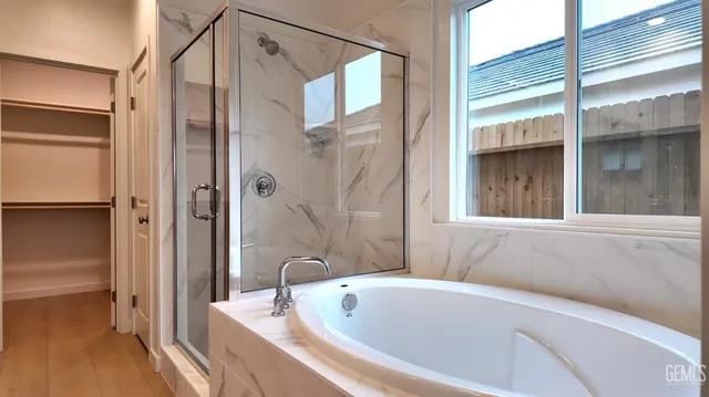 a bathroom with a tub and shower
