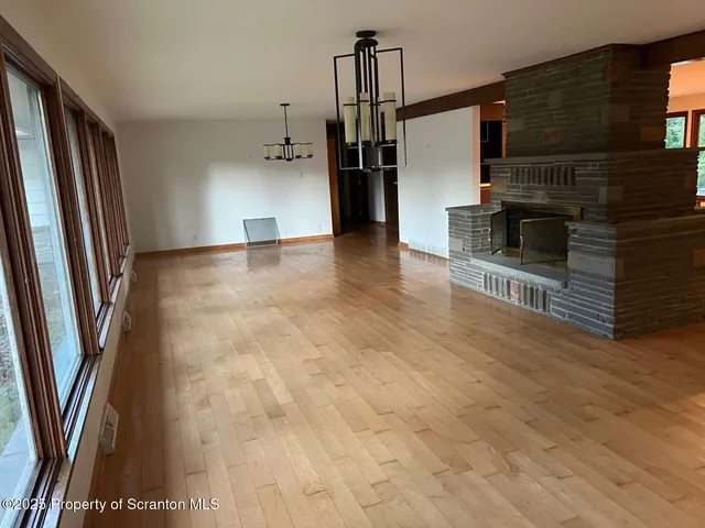 a living room with stainless steel appliances kitchen island granite countertop furniture and a fireplace