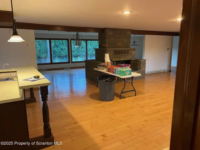a living room with furniture a rug and a floor to ceiling window