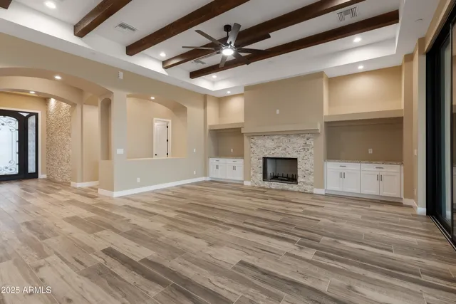 a view of a hallway with wooden floor and closet