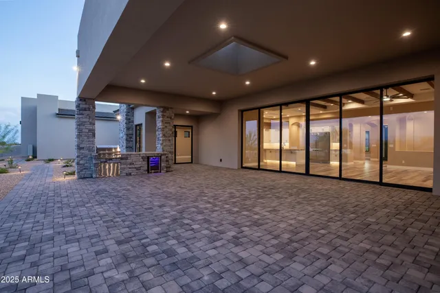 a view of a hallway with wooden floor and a bathroom