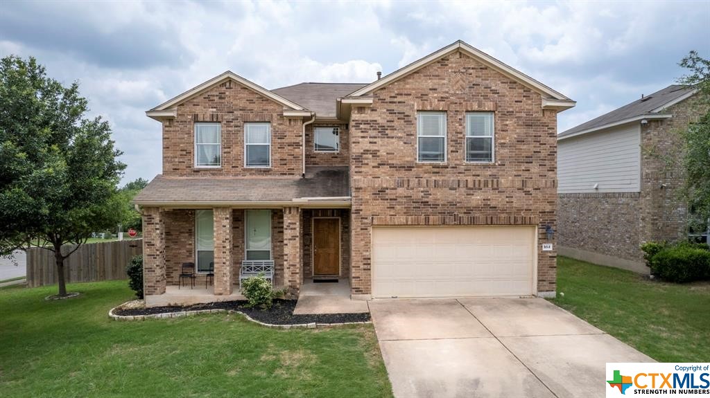 a front view of a house with a yard and garage