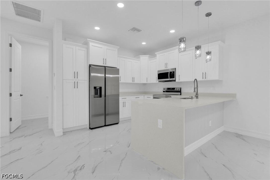 2115 Polar Avenue Alva, FL 33920 - Photo 11 of 26 a kitchen with stainless steel appliances granite countertop a refrigerator and a stove