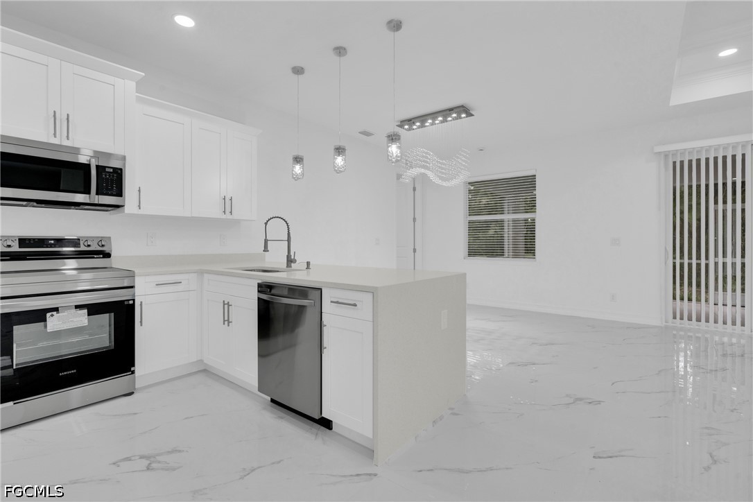 2115 Polar Avenue Alva, FL 33920 - Photo 12 of 26 a kitchen with stainless steel appliances granite countertop a stove and a sink