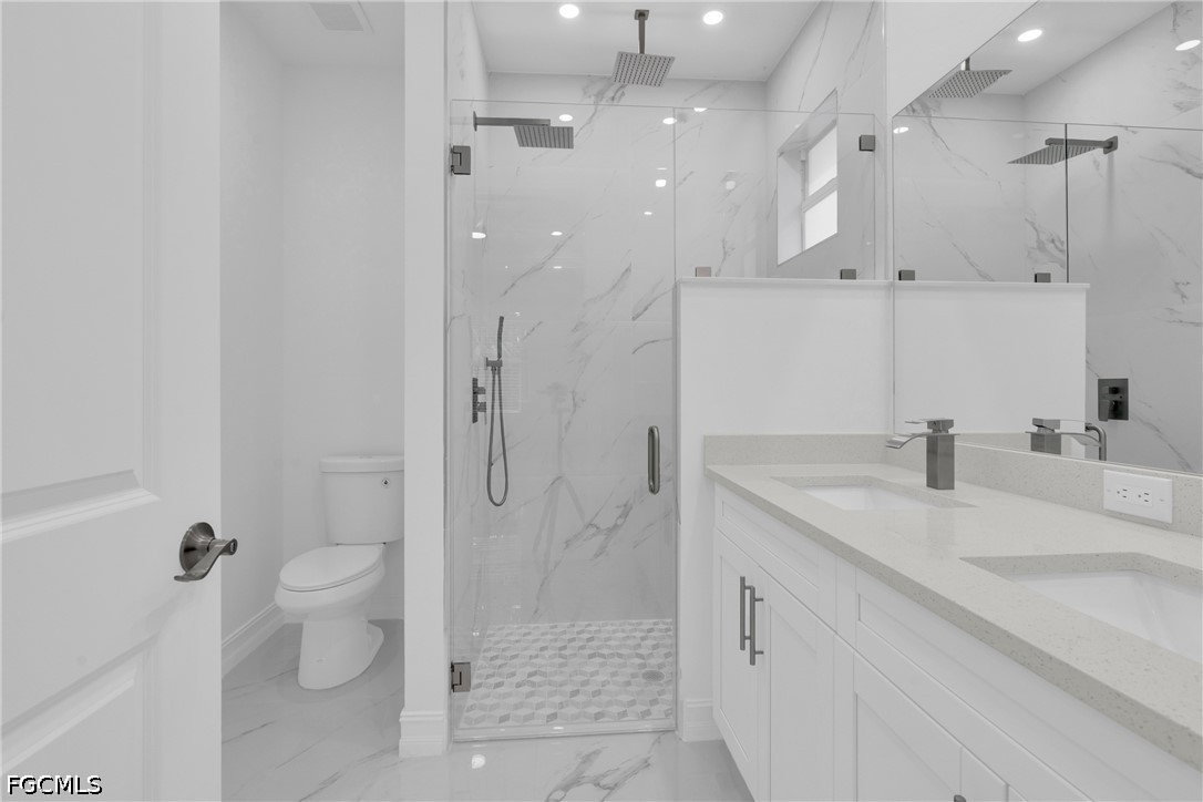 2115 Polar Avenue Alva, FL 33920 - Photo 18 of 26 a bathroom with a granite countertop sink a toilet and shower