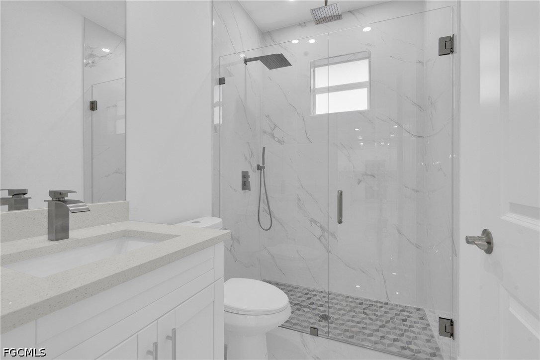 2115 Polar Avenue Alva, FL 33920 - Photo 21 of 26 a bathroom with a sink a toilet and shower