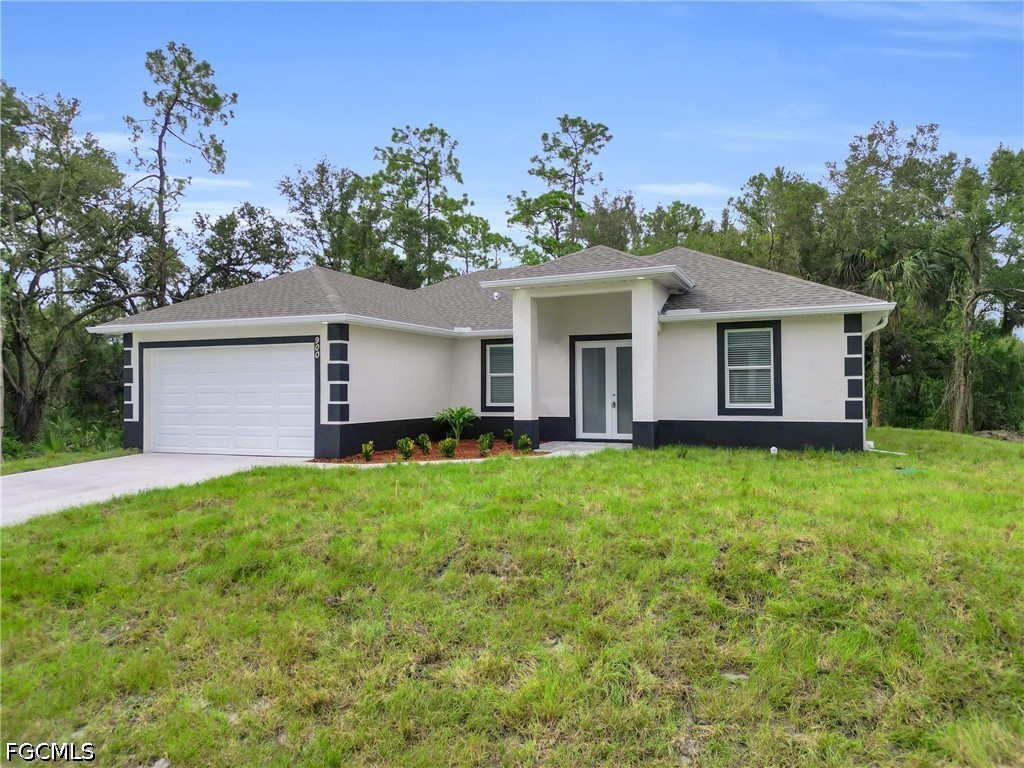 2115 Polar Avenue Alva, FL 33920 - Photo 3 of 26 a front view of a house with a garden