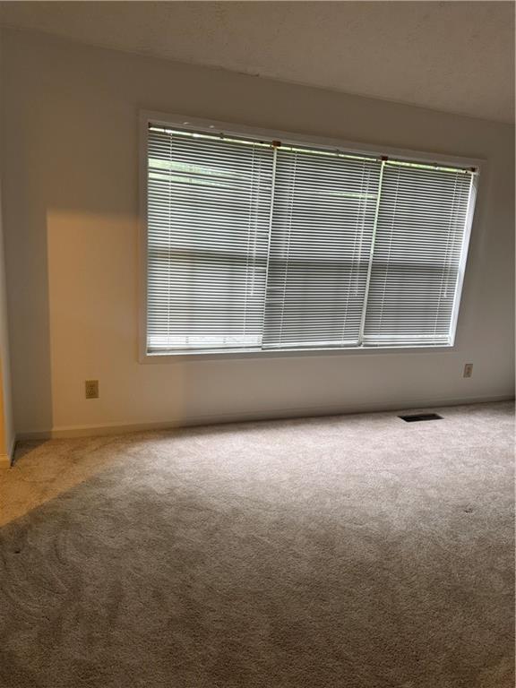 682 Bridge Way Lithonia, GA 30058 - Photo 12 of 25 an empty room with a empty space and a window