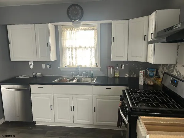 a kitchen with a sink stove and cabinets