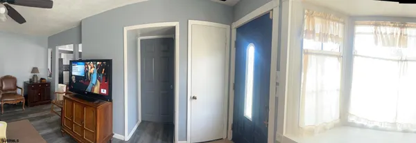 a kitchen with granite countertop a stove a sink and a white cabinets