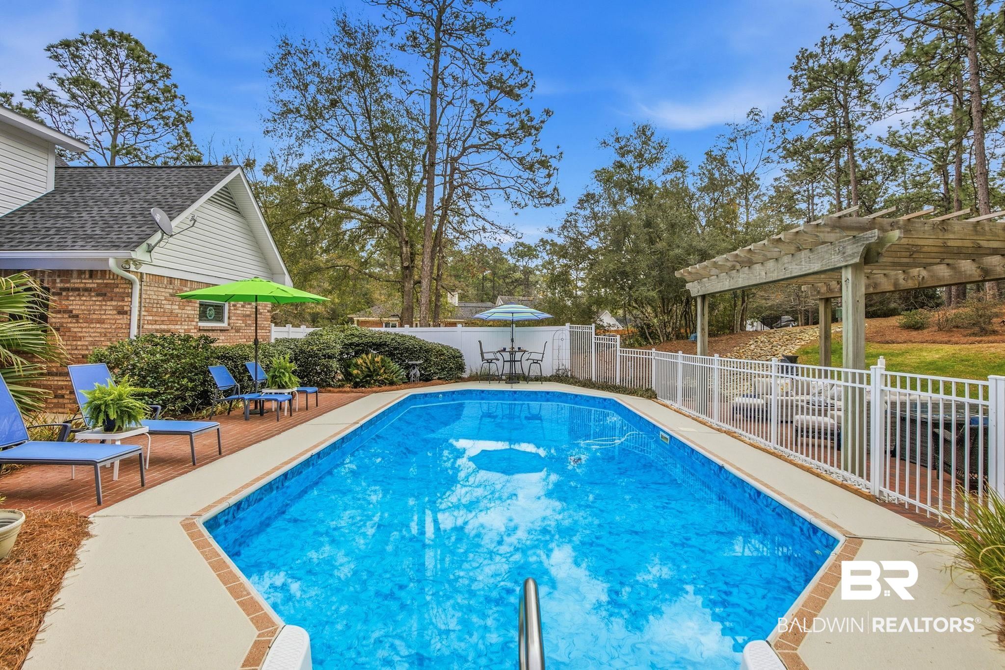 31515 Rhett Drive Spanish Fort, AL 36527 - Photo 74 of 100 32000 gallon pool. All pool furniture and equipment will convey with the home. (Liner replaced in 2023; sand filter in 2025). Pool deck was recently leveled with a 5 year warranty.