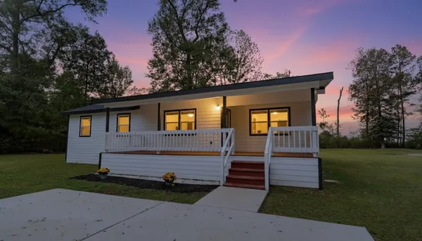 a front view of a house with garden