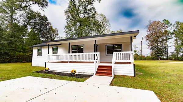 a view of a swimming pool with a big yard and large trees