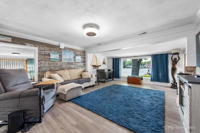 a living room with furniture large window and flat screen tv