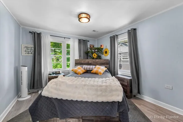 a bed sitting in a bedroom next to a window