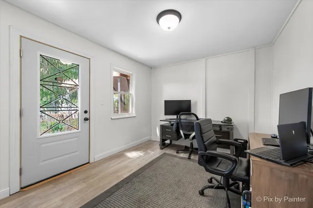 a view of a workspace with furniture and a window