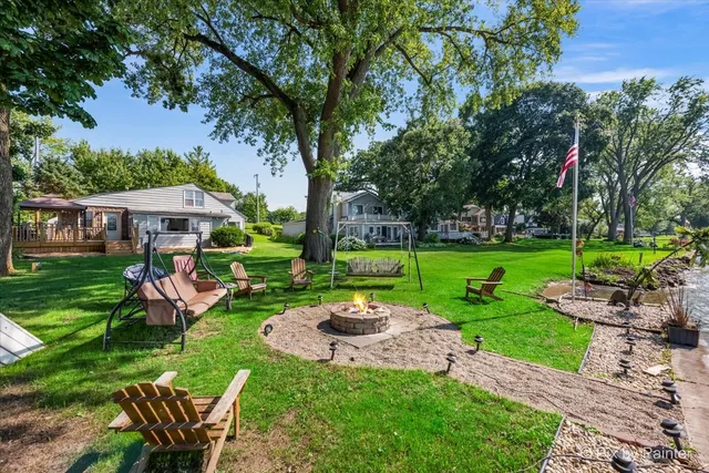 a view of a table and chairs in backyard of the house