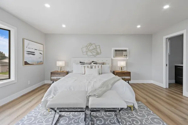 a bedroom with a bed and a potted plant