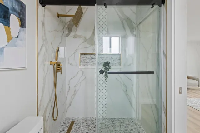 a bedroom with a large bed and a potted plant