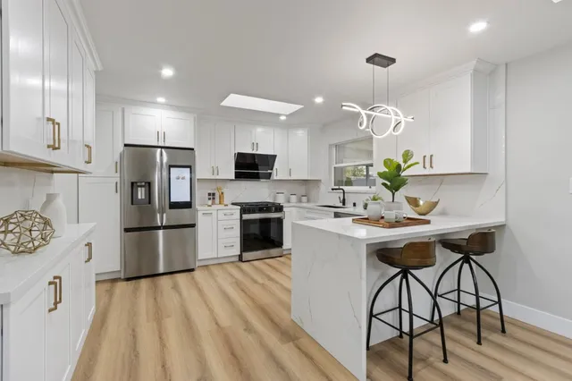 a kitchen with a refrigerator stove and microwave
