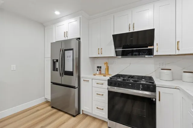 a kitchen with a sink stove and cabinets