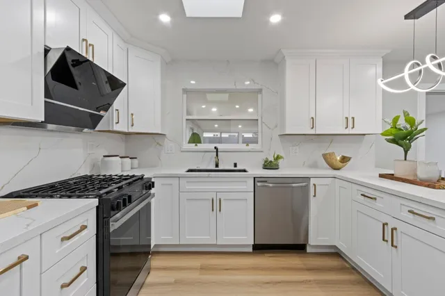 a kitchen with a dining table cabinets and appliances
