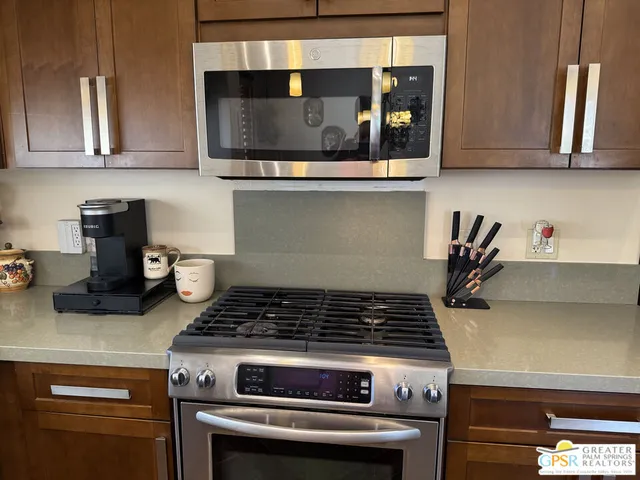 a stove top oven sitting inside of a kitchen
