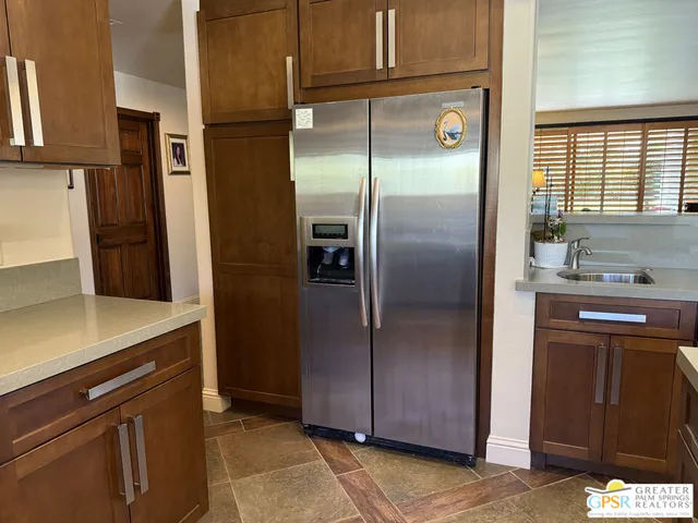 a kitchen with a wooden floor and cabinets