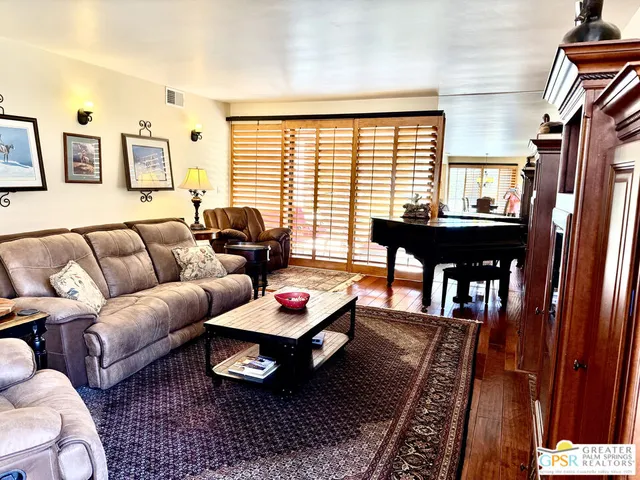 a living room with furniture fireplace and flat screen tv