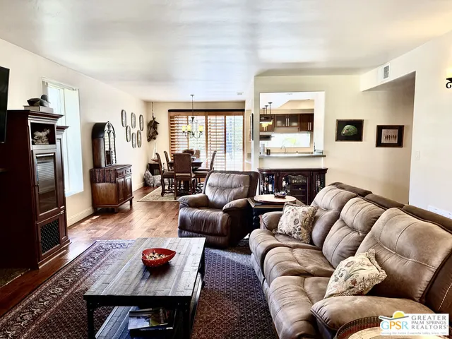 a living room with a fireplace and a wooden floor