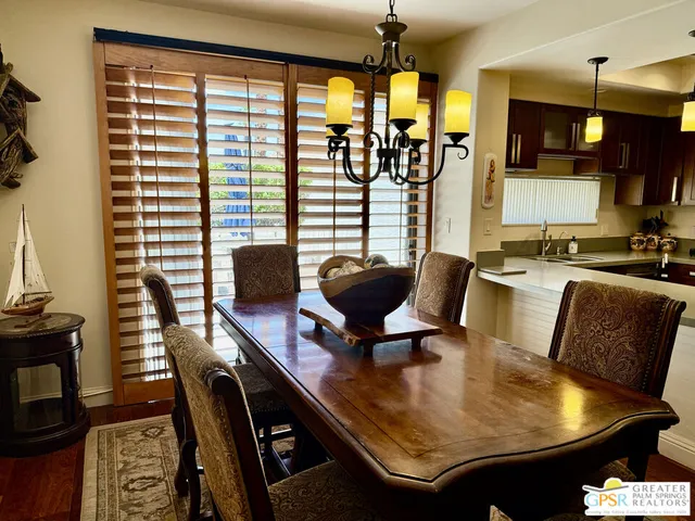 a dining room with furniture and wooden floor