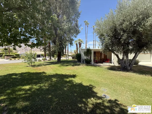 a swimming pool with outdoor seating and yard