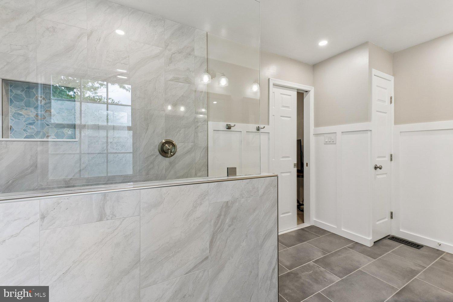 3707 Turn Back Trail Triangle, VA 22172 - Photo 32 of 55 a view of a bathroom with a glass shower door
