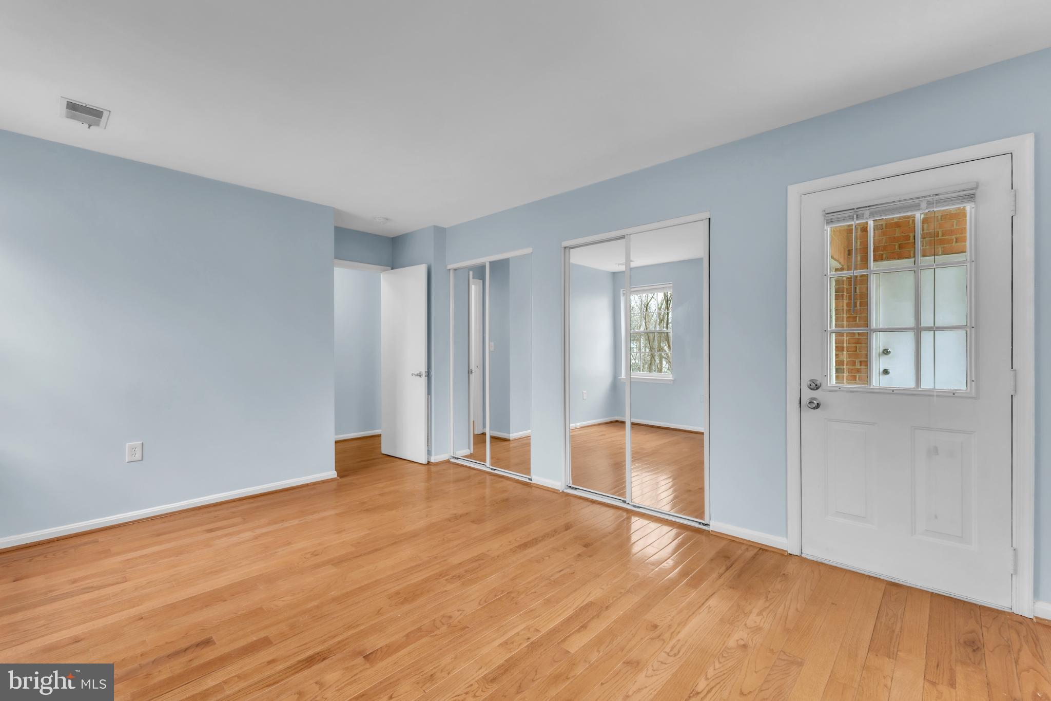 18334 Streamside Drive, Unit 201 Gaithersburg, MD 20879 - Photo 14 of 22 a big room with wooden floor and natural light