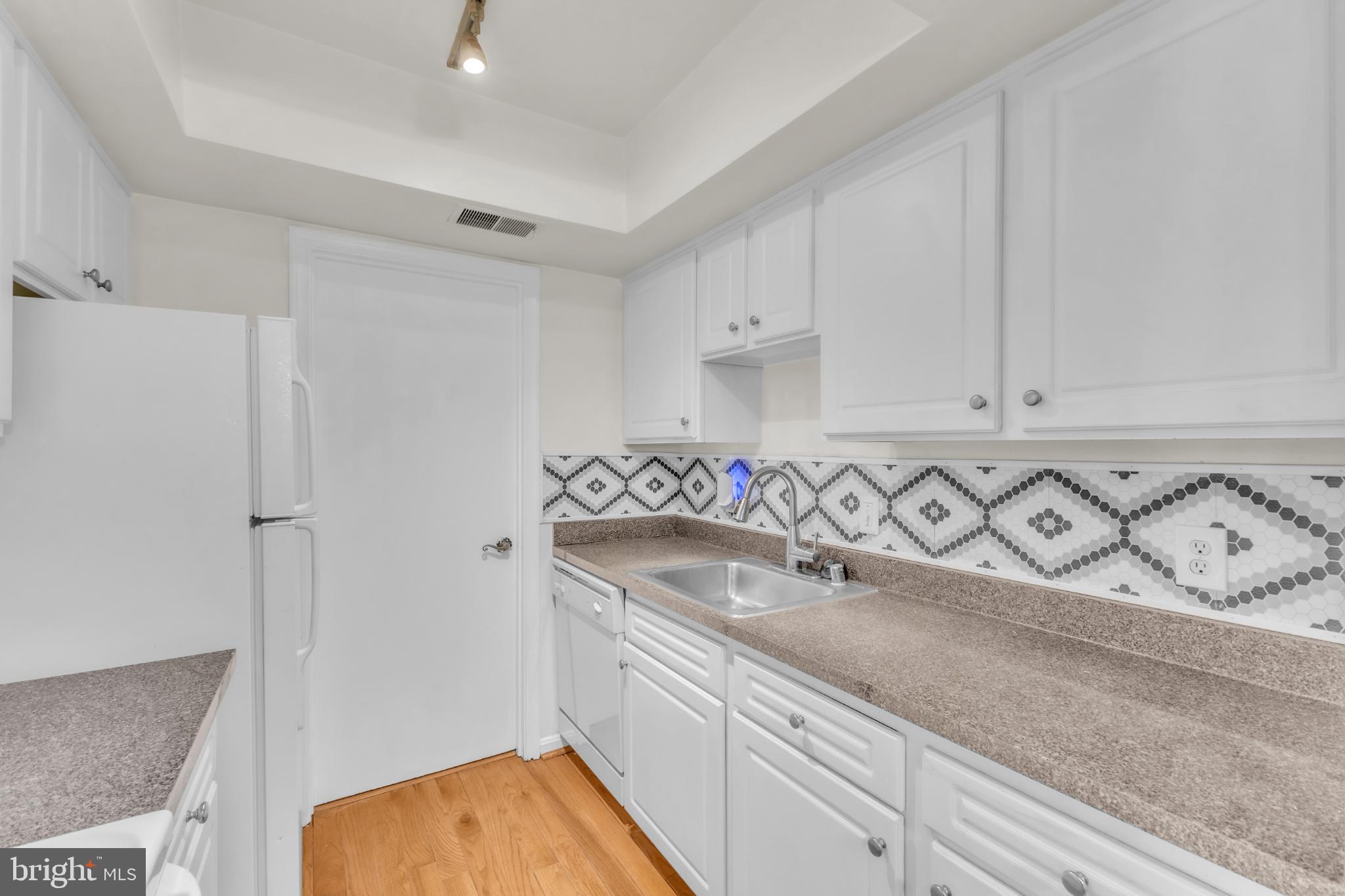 18334 Streamside Drive, Unit 201 Gaithersburg, MD 20879 - Photo 18 of 22 a bathroom with a sink and a mirror