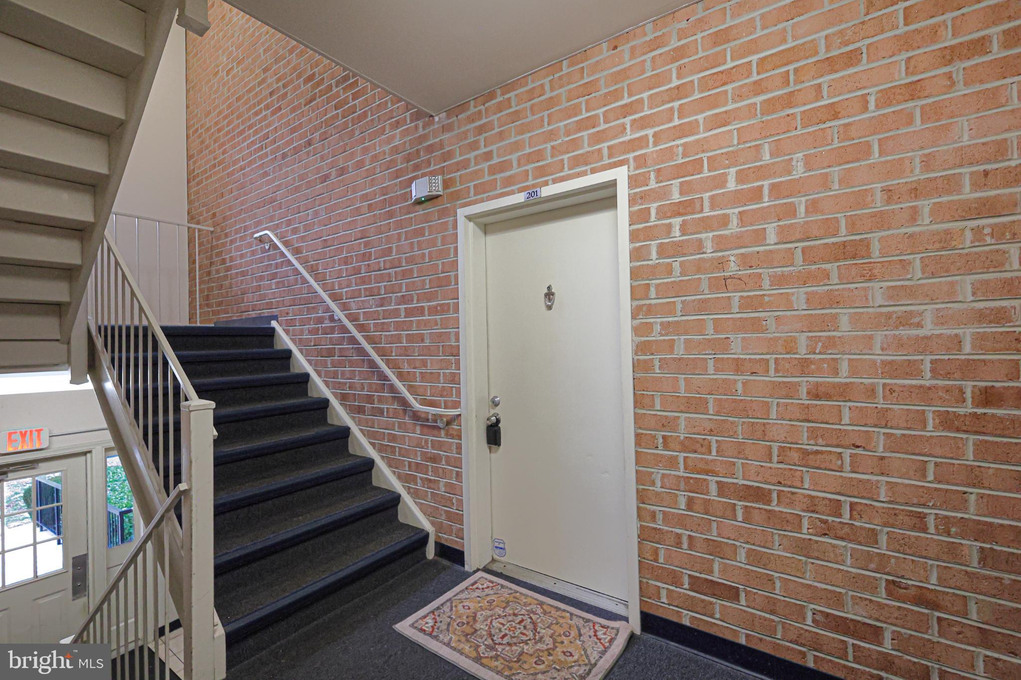 18334 Streamside Drive, Unit 201 Gaithersburg, MD 20879 - Photo 2 of 22 a view of wooden door with stairs