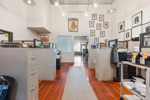 a view of a kitchen with fridge and workspace