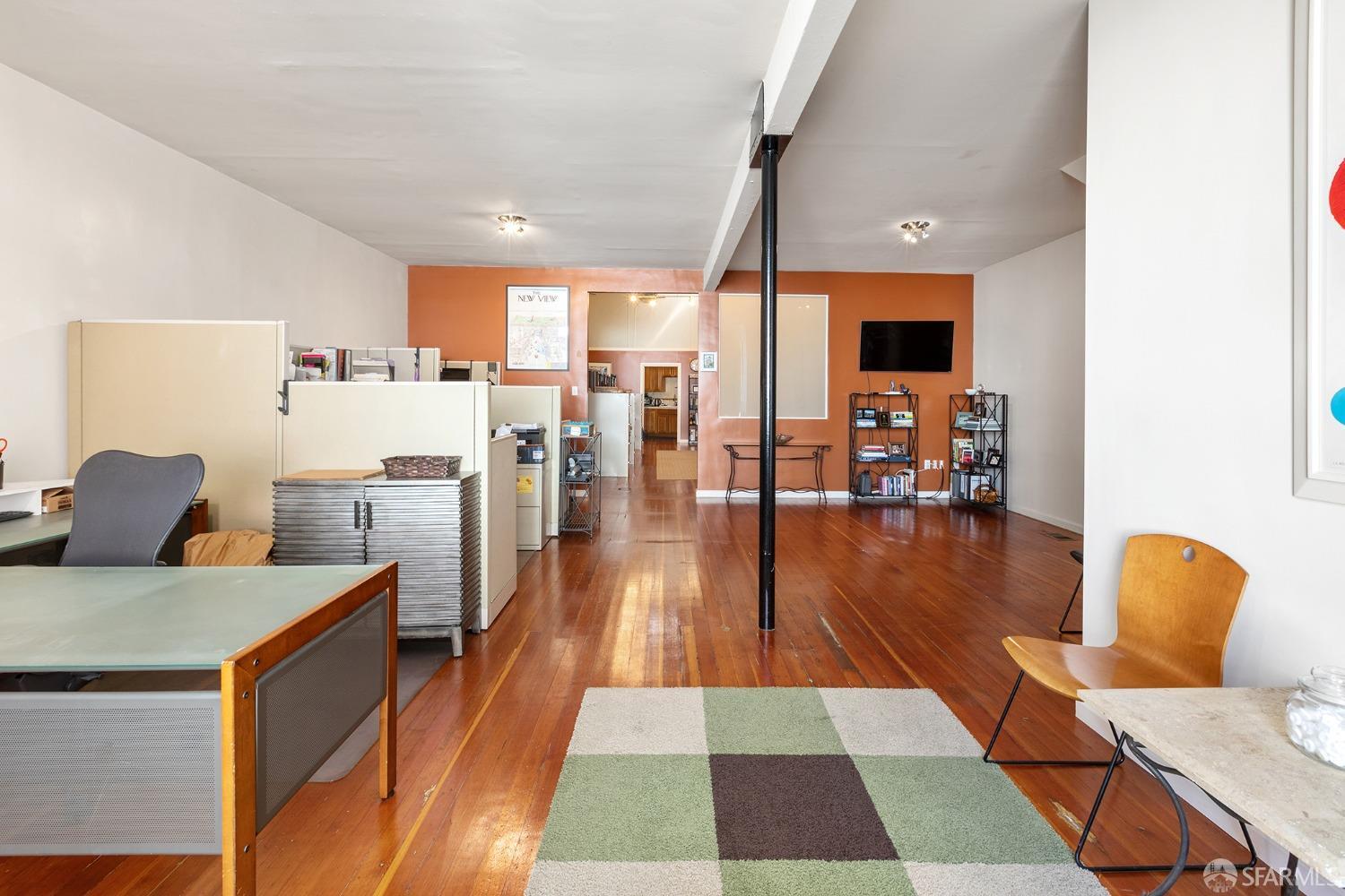 67-71 Haight Street San Francisco, CA 94102 - Photo 20 of 25 a living room with stainless steel appliances furniture wooden floor and a view of kitchen